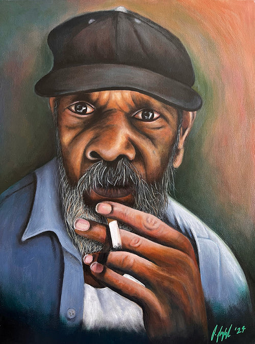 Artistic portrait of a man smoking a cigarette with a blurred background